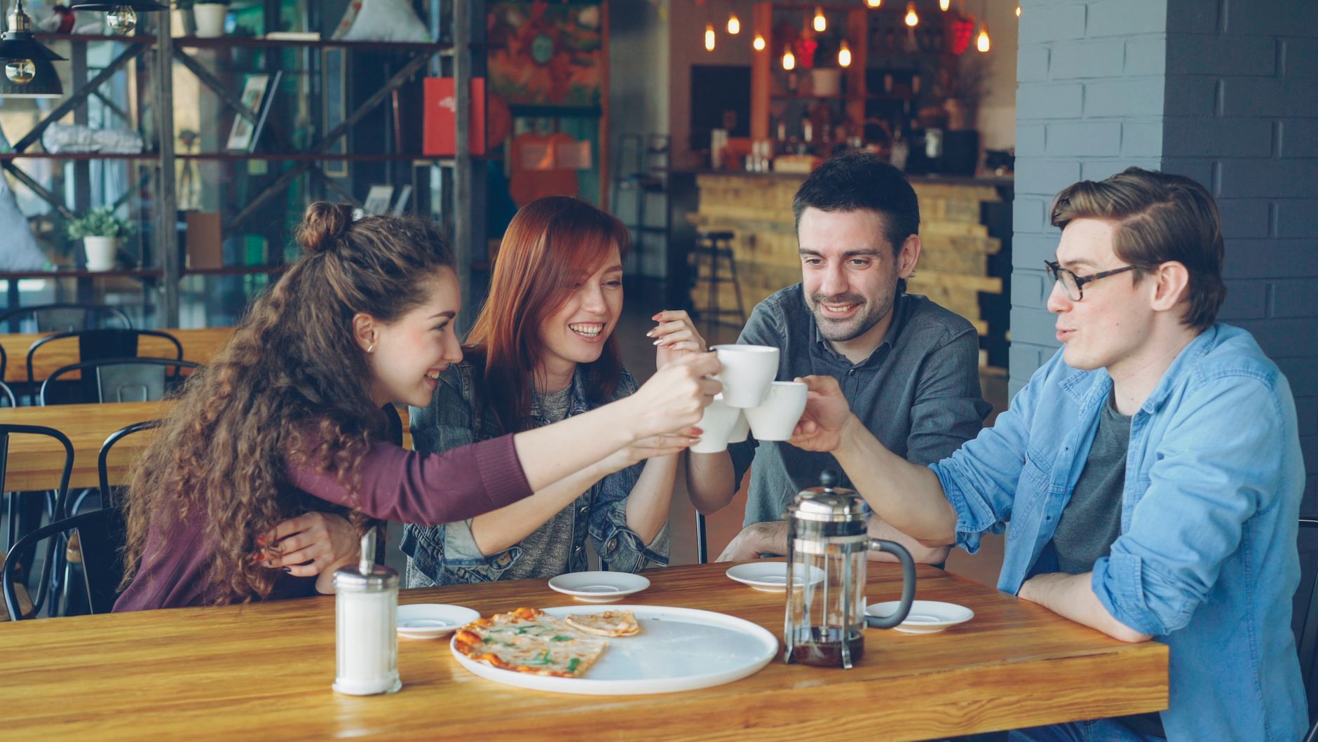 Diverse team smiling while using premium office coffee equipment