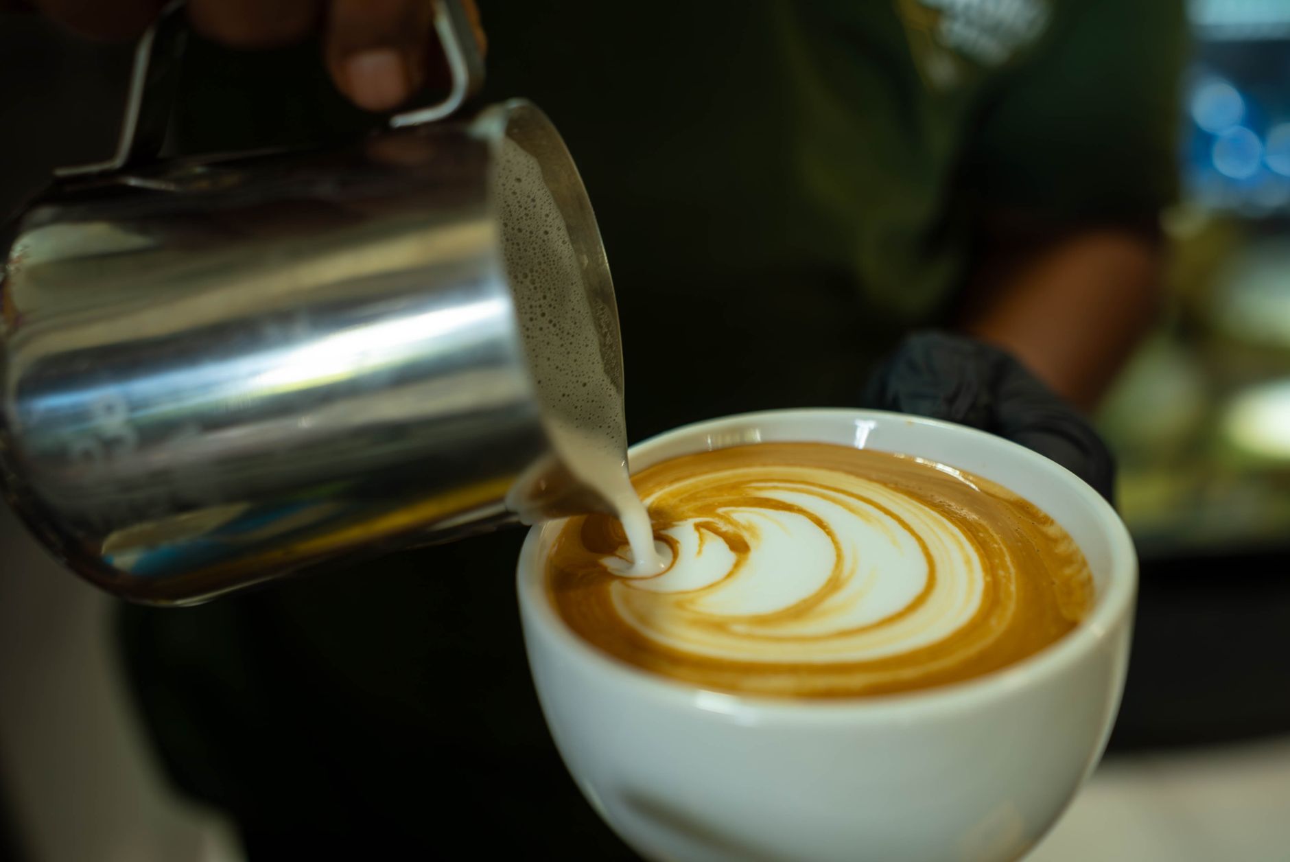 Professional barista preparing espresso in a busy restaurant setting