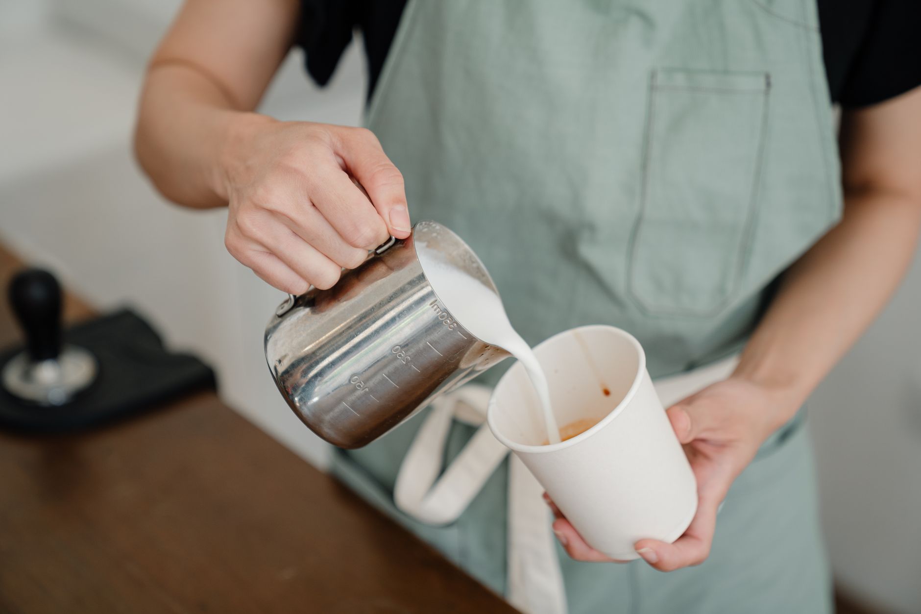 Skilled barista efficiently preparing multiple coffee drinks during peak hours