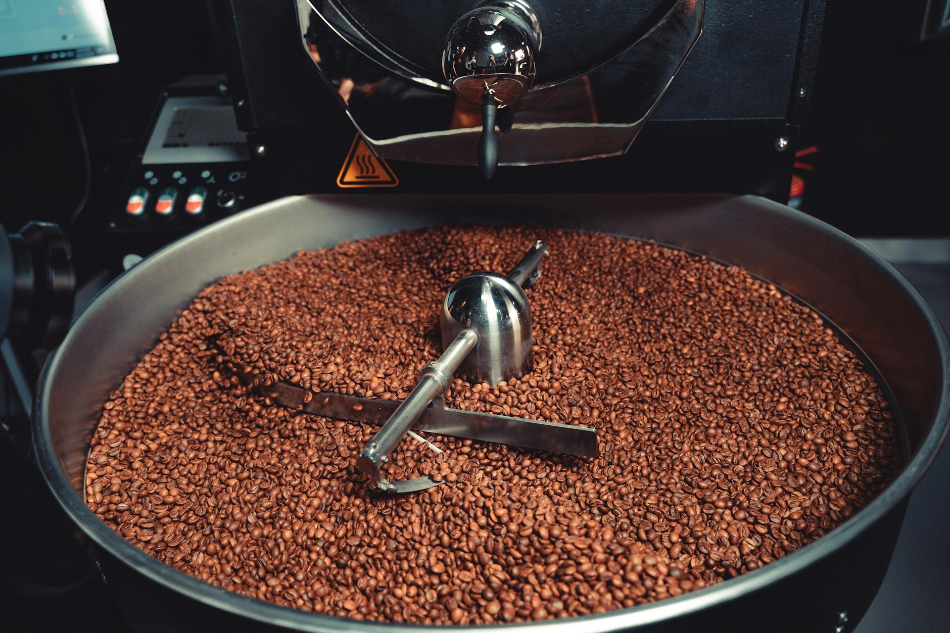 Industrial coffee roaster in a factory setting