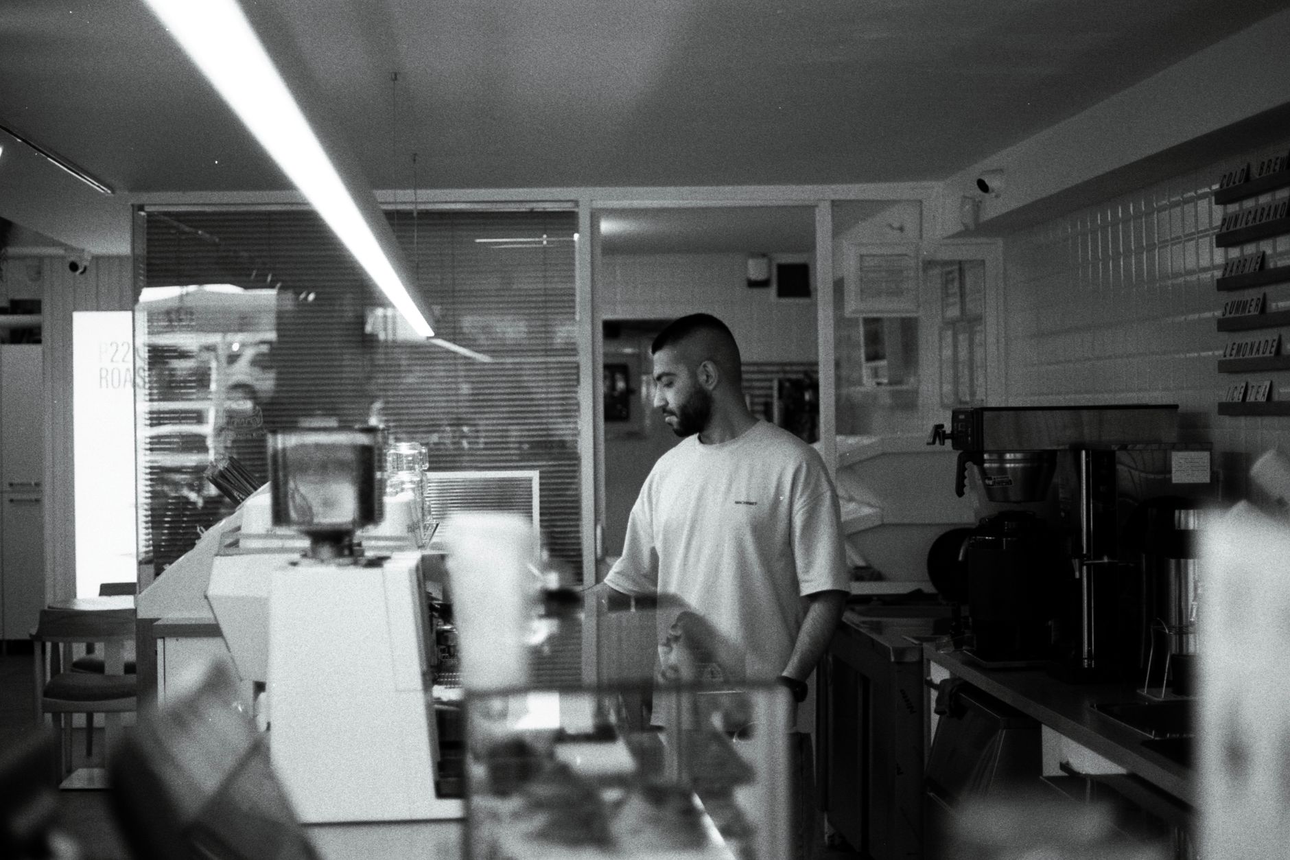 Barista cleaning an espresso machine in a Norfolk coffee shop