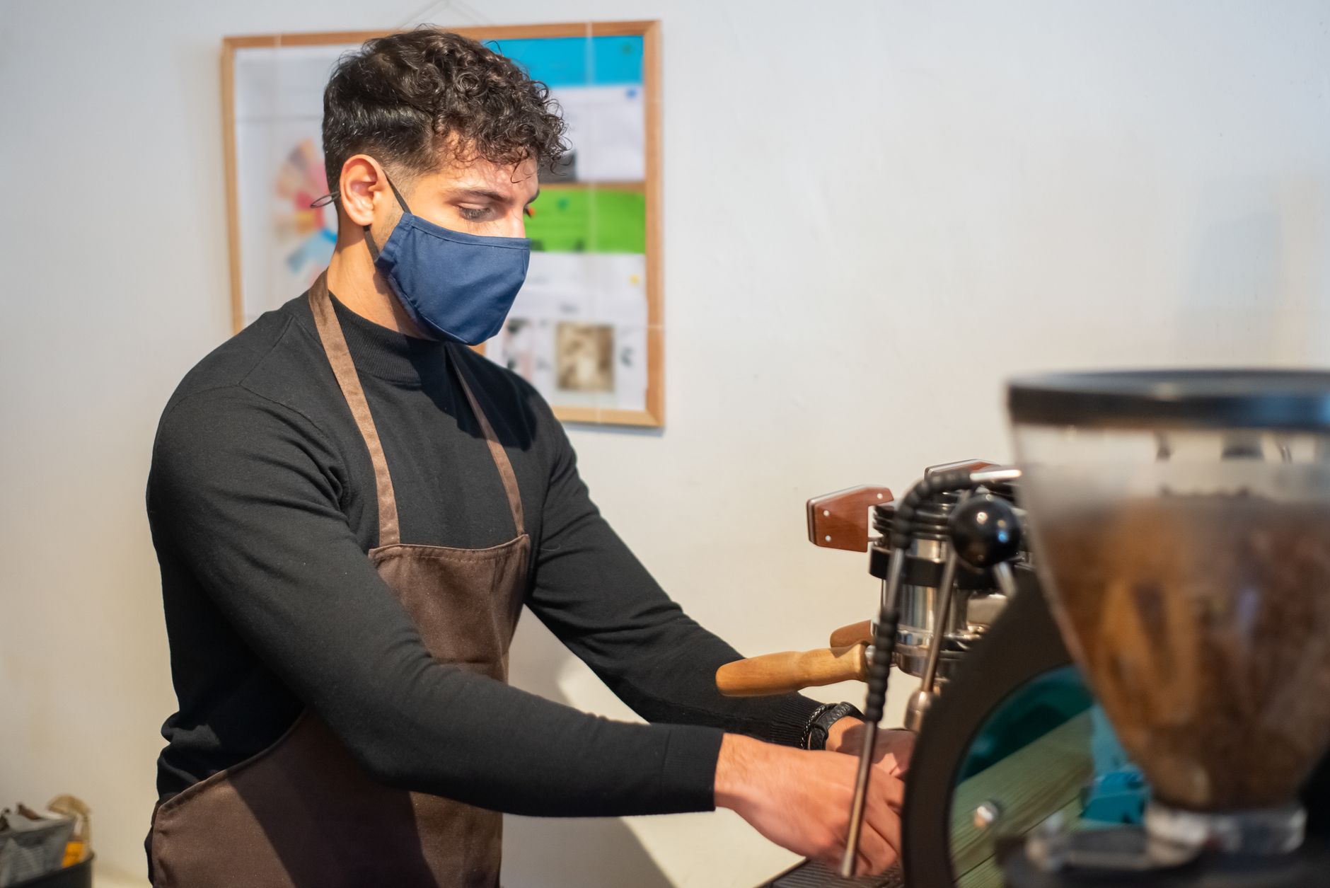 Certified technician calibrating commercial espresso machine