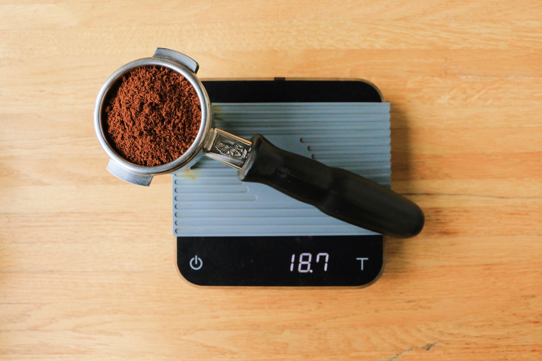 Close-up of espresso shot being weighed on a professional coffee scale