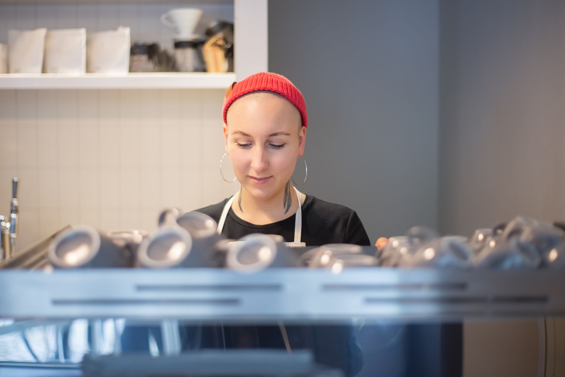 Professional barista creating latte art in a bakery setting