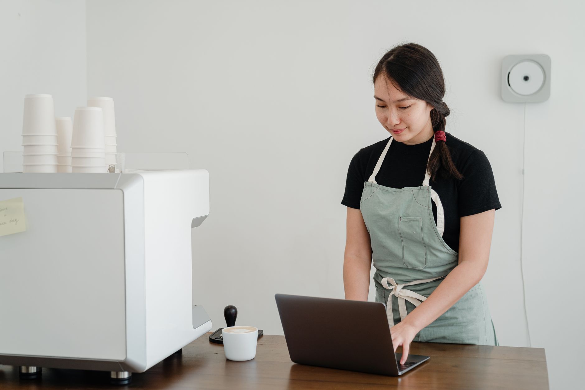 Professional barista operating leased commercial espresso machine