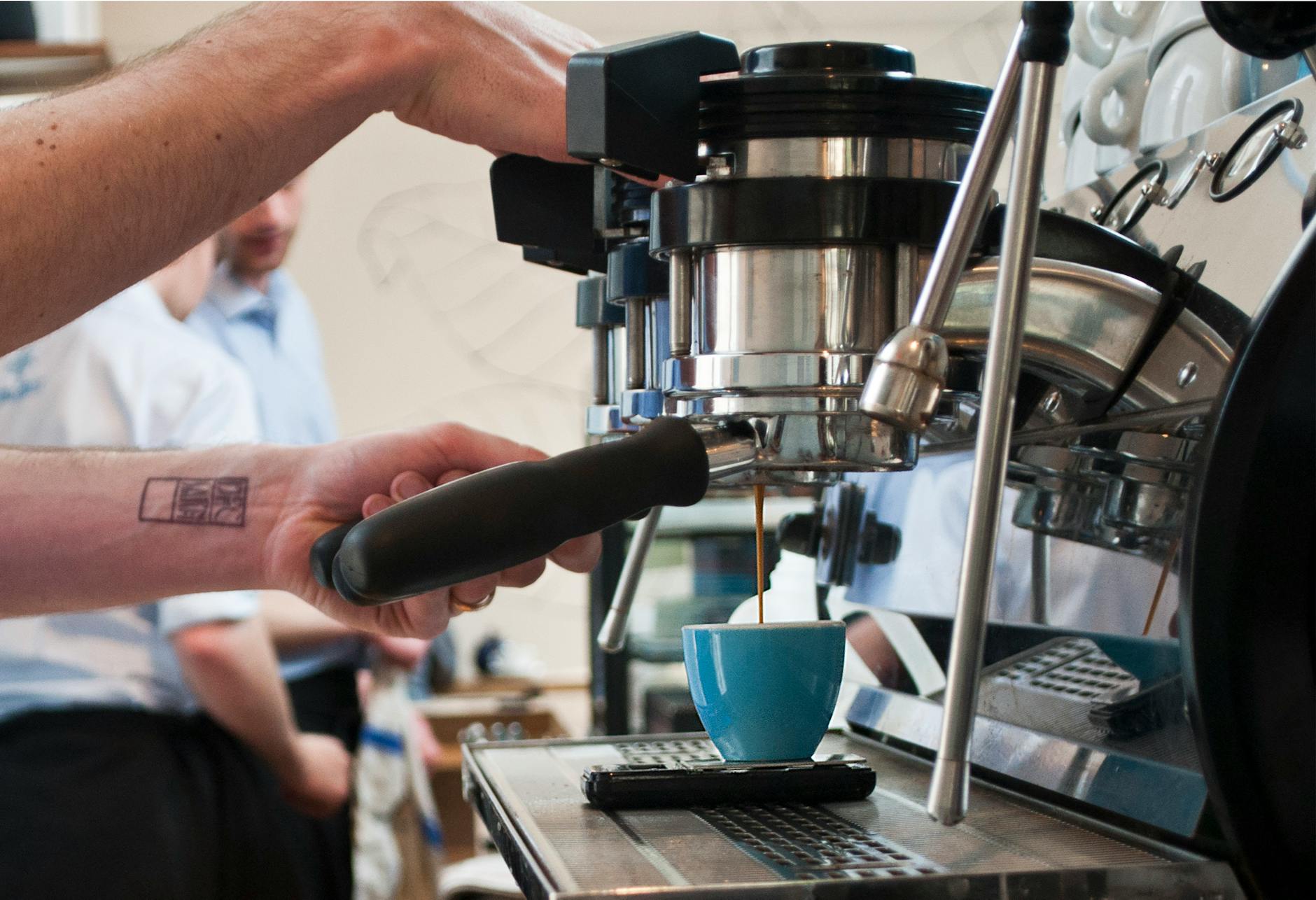 Technician maintaining commercial coffee machine