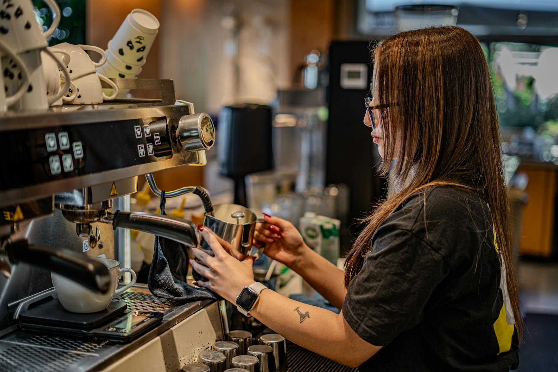 Barista cleaning commercial espresso machine