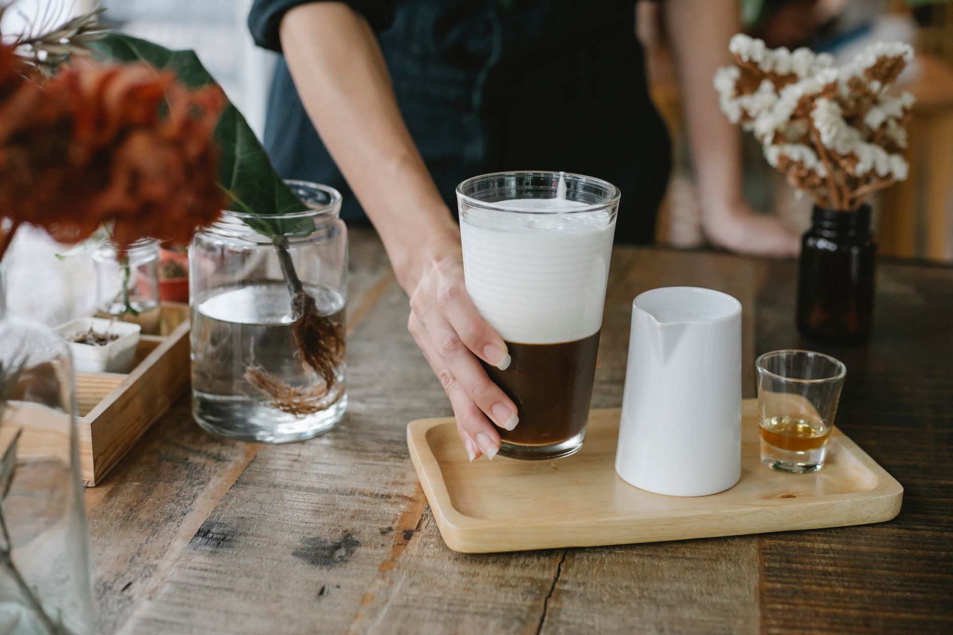 Professional barista serving craft coffee in a Seattle luxury hotel lobby