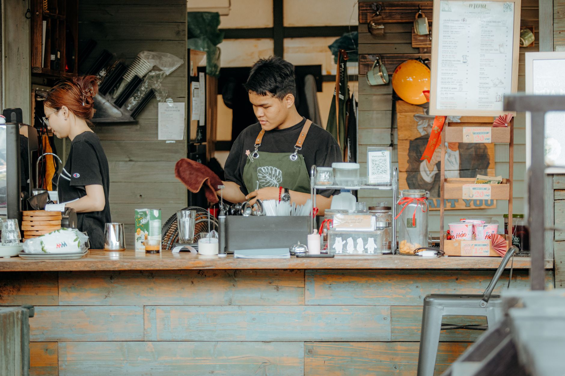 Professional barista preparing coffee in a bakery setting
