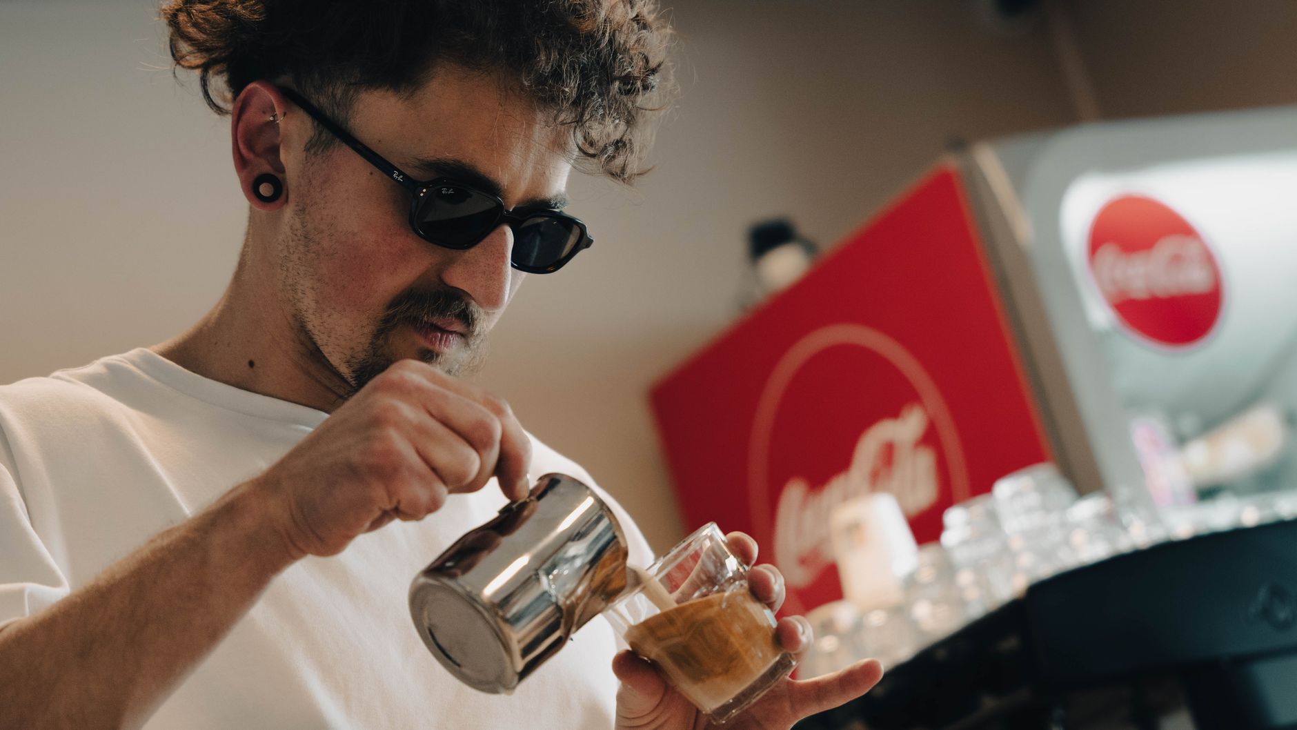 Barista preparing specialty coffee in a modern office break room