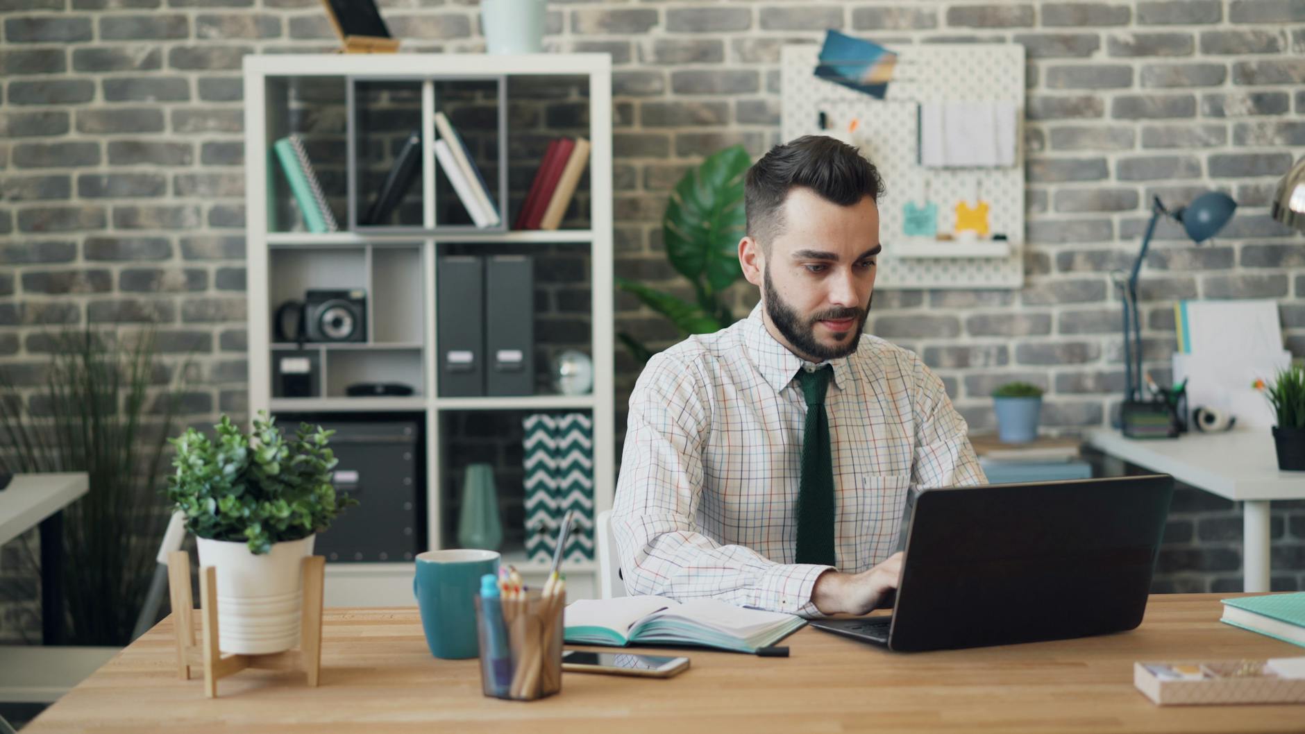 Focused employees at desks with coffee mugs nearby
