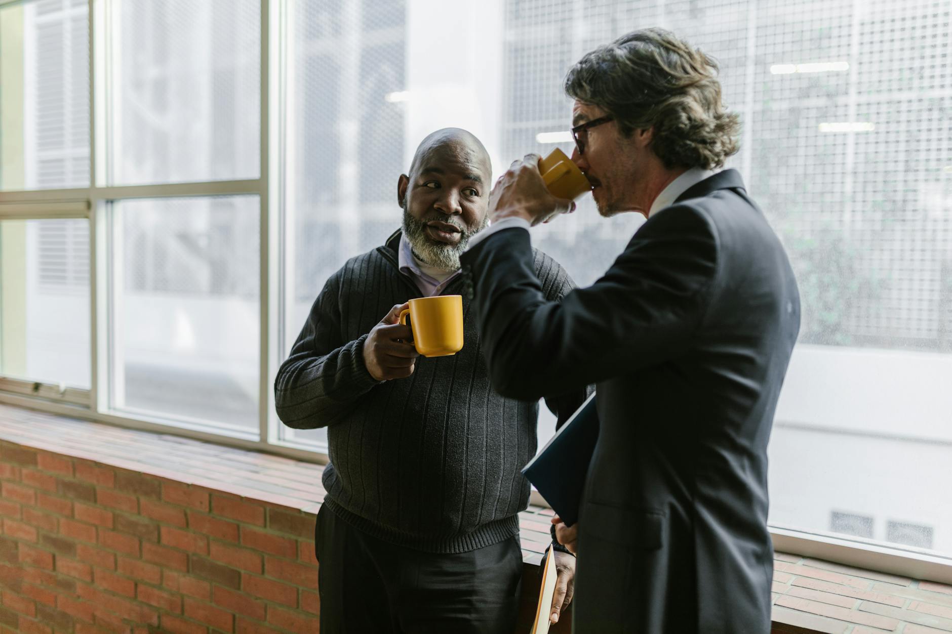 Employees enjoying sustainable coffee in modern office break room