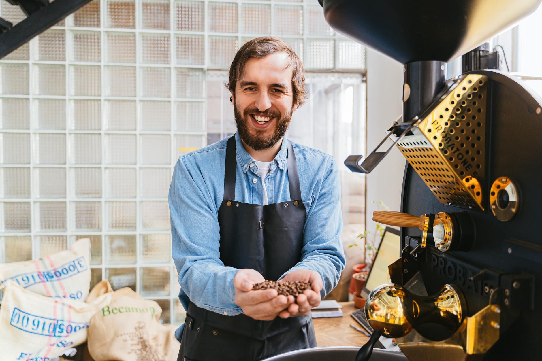 Mechanic installing large coffee roaster in warehouse