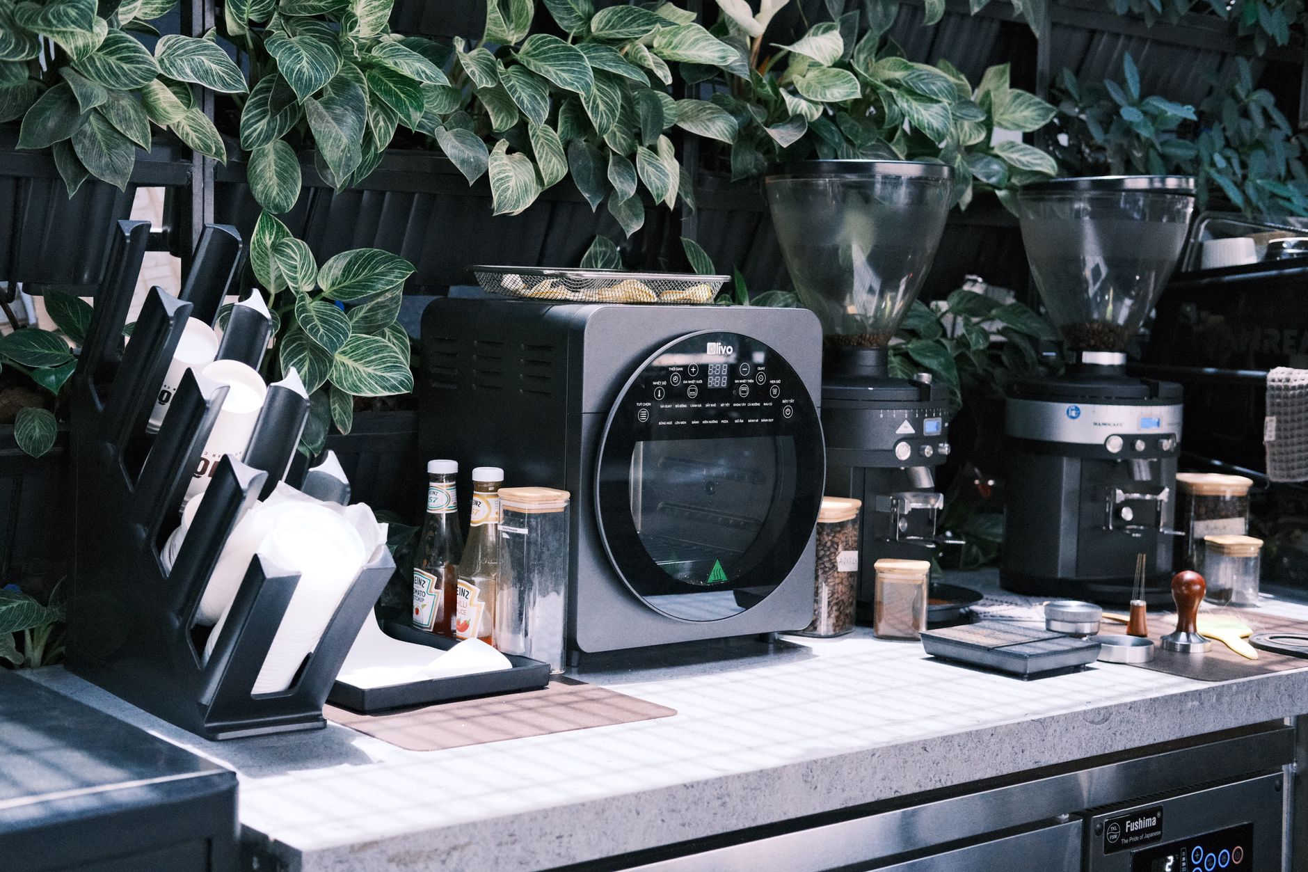 Barista preparing espresso drinks in modern bakery setting