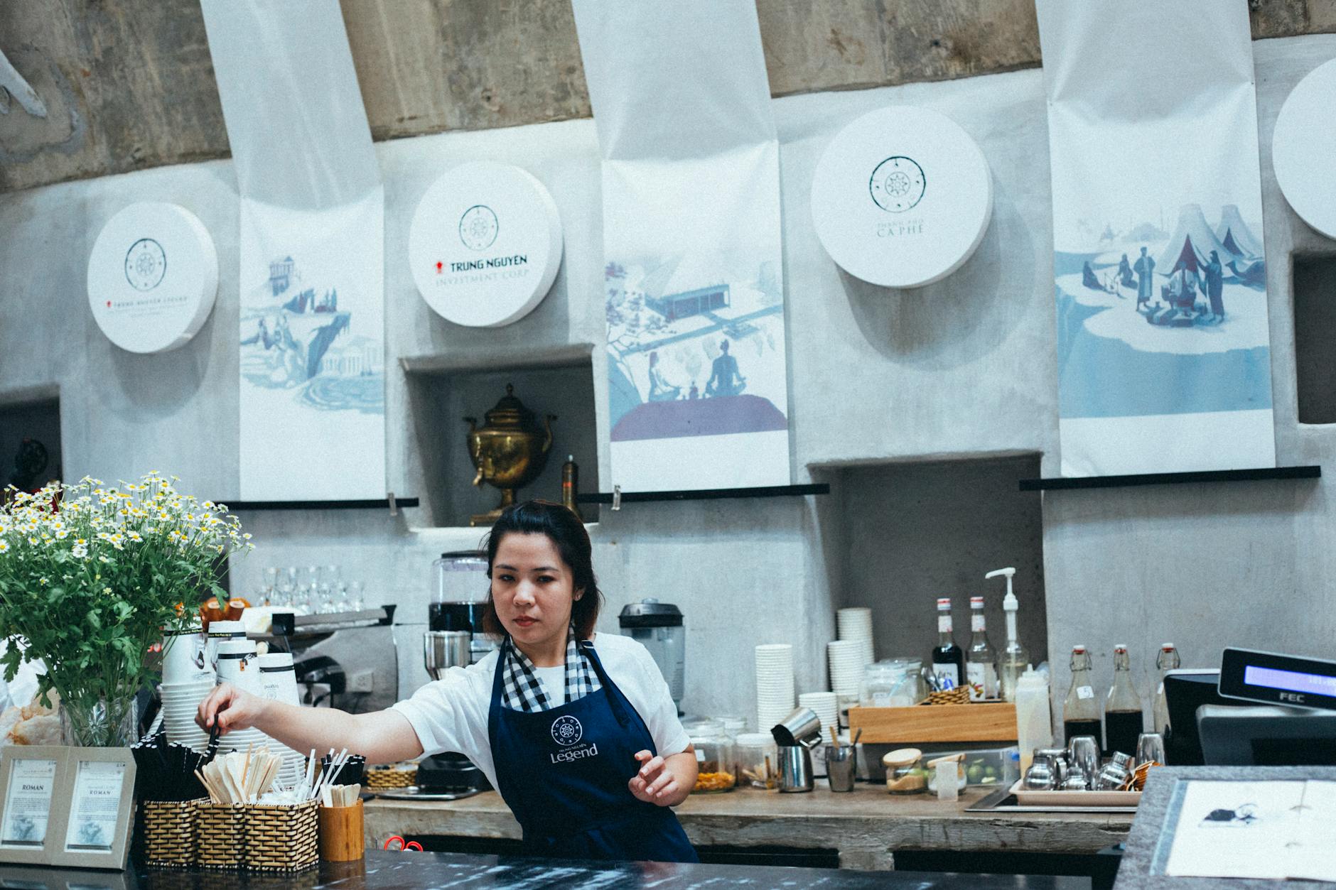 Barista serving coffee in busy Norfolk VA restaurant