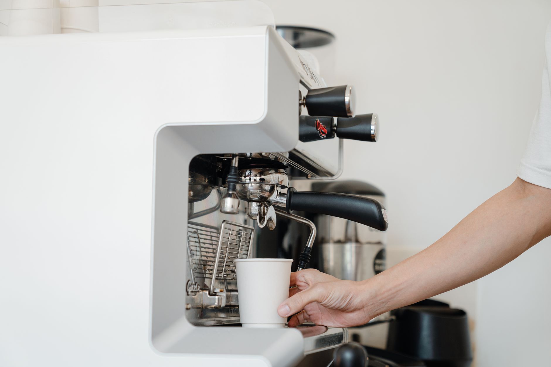 Professional barista preparing espresso on a leased commercial machine