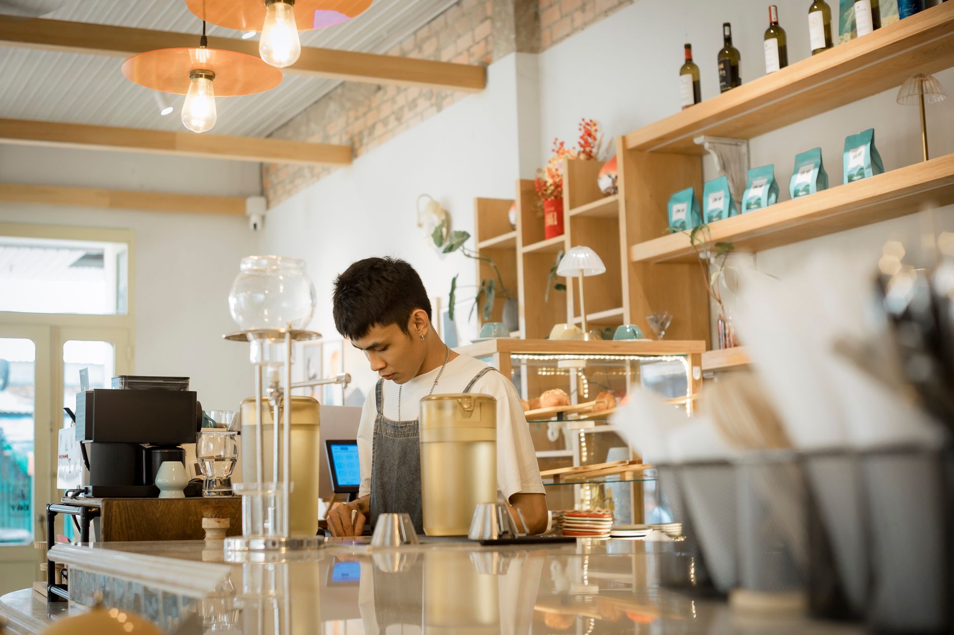 Professional barista using stainless steel dosing funnel on portafilter