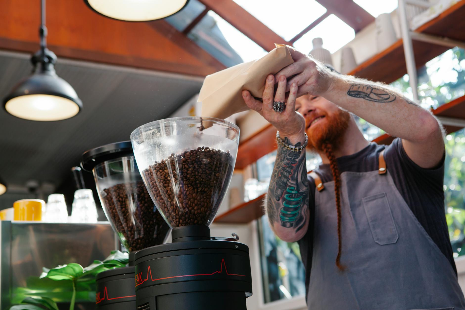 Close-up of a burr coffee grinder with visible grind size adjustment dial