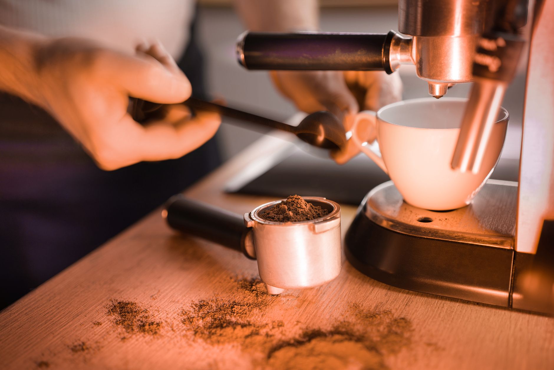 Professional barista preparing coffee in corporate office setting