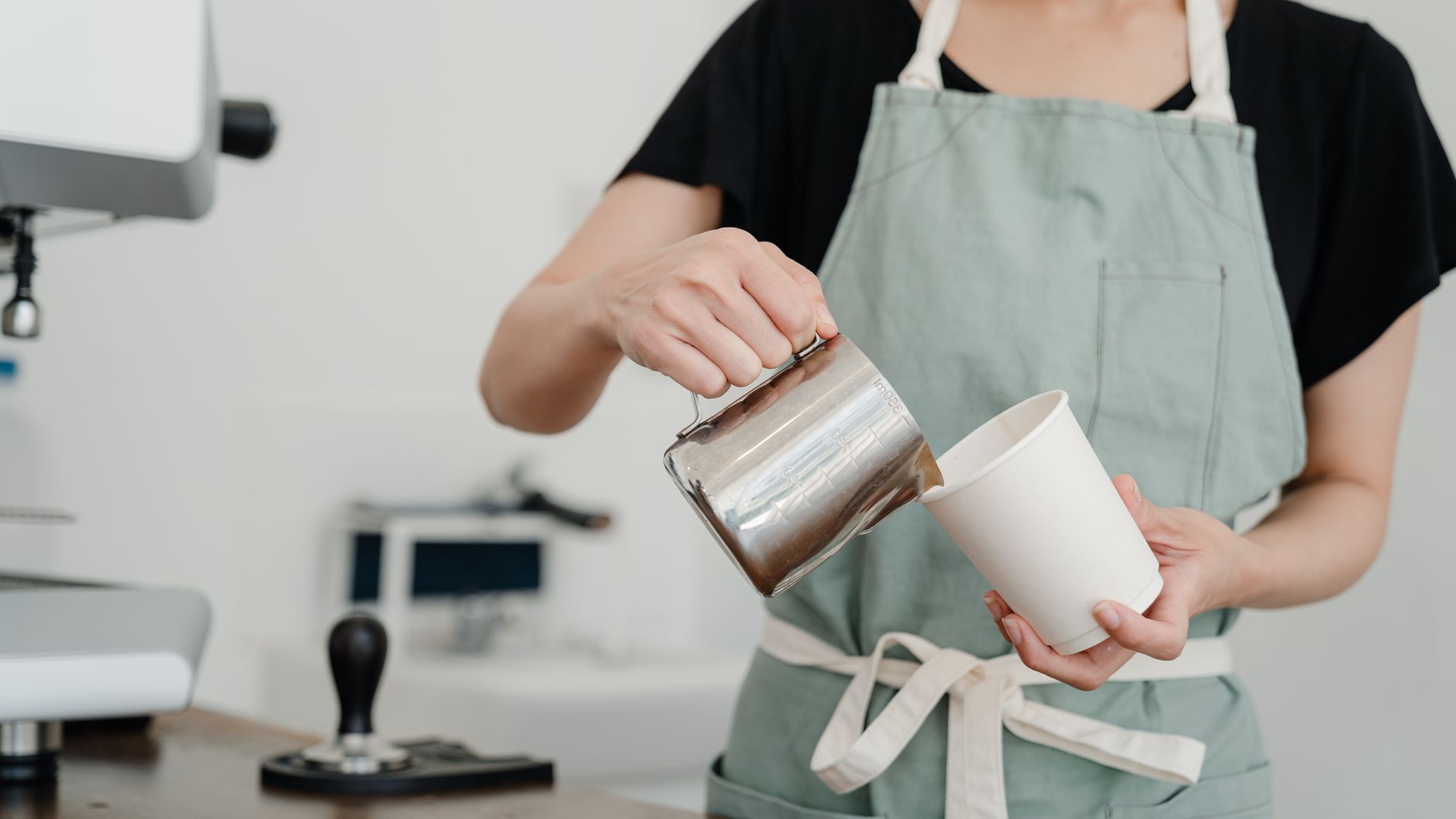 Professional barista preparing espresso in a corporate cafe setting