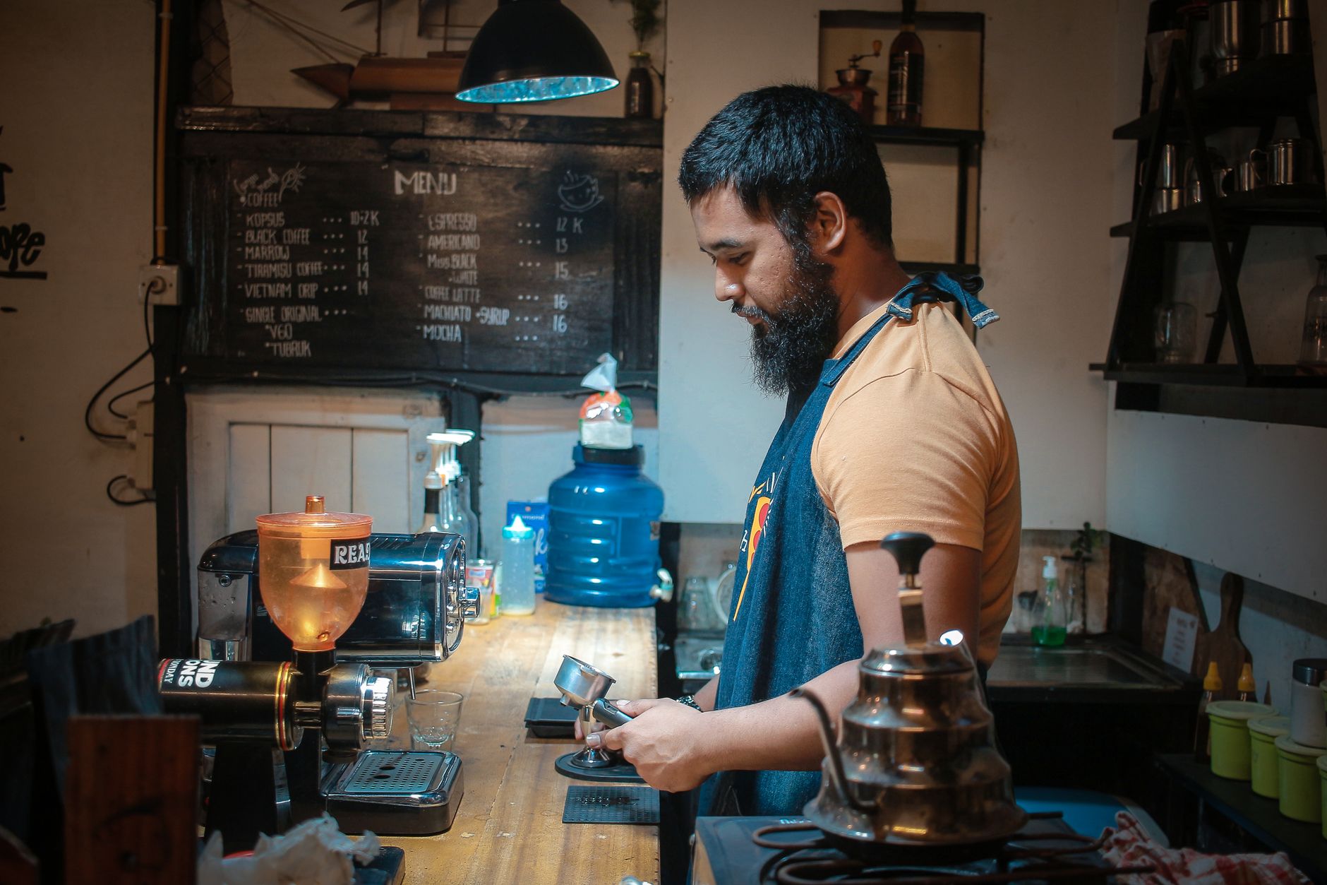 Certified technician performing preventive maintenance on commercial coffee equipment