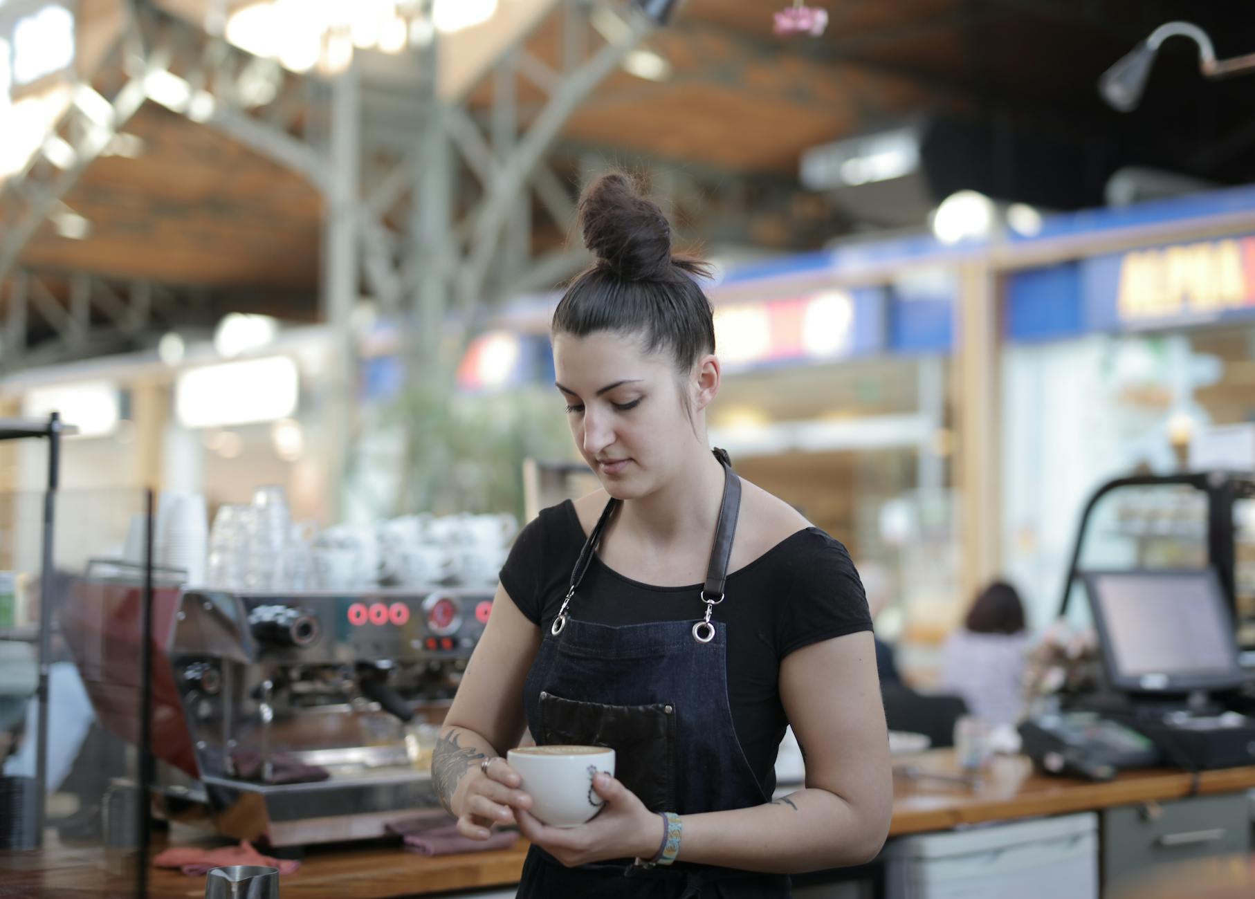 Modern cafe counter with coffee machine and pastries