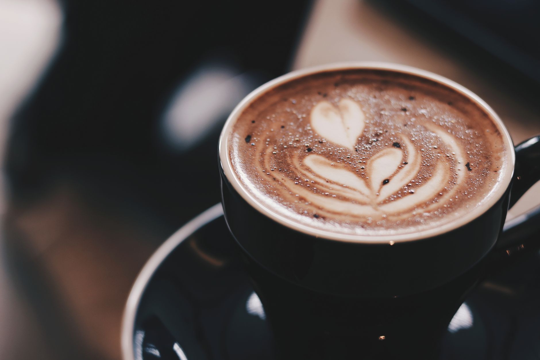 Barista preparing fresh coffee with automated bean to cup system