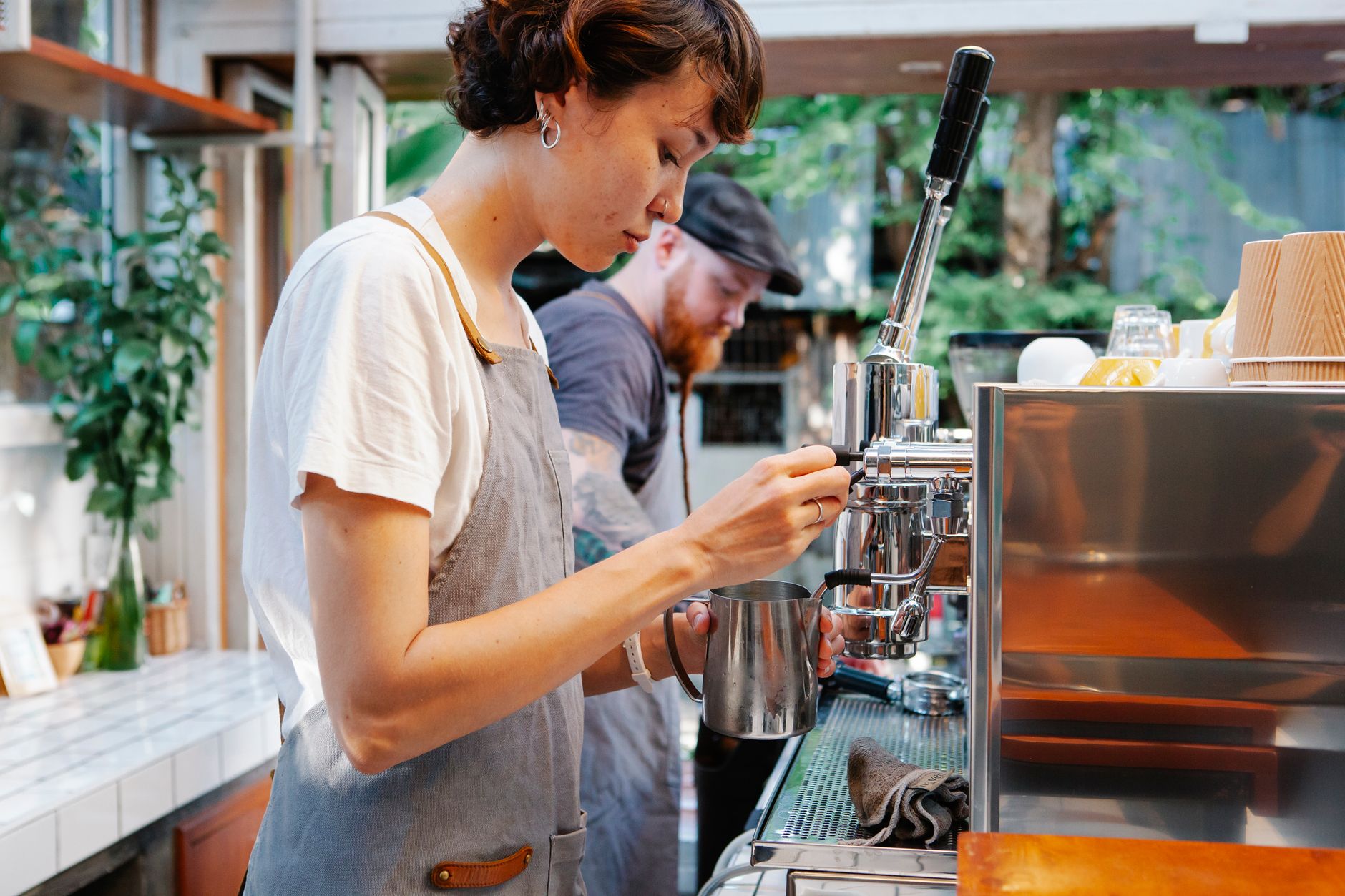 Barista using bean to cup equipment in Greenville