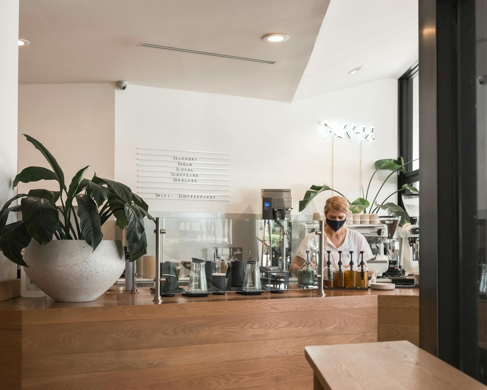 Modern office cafe counter with employees enjoying coffee
