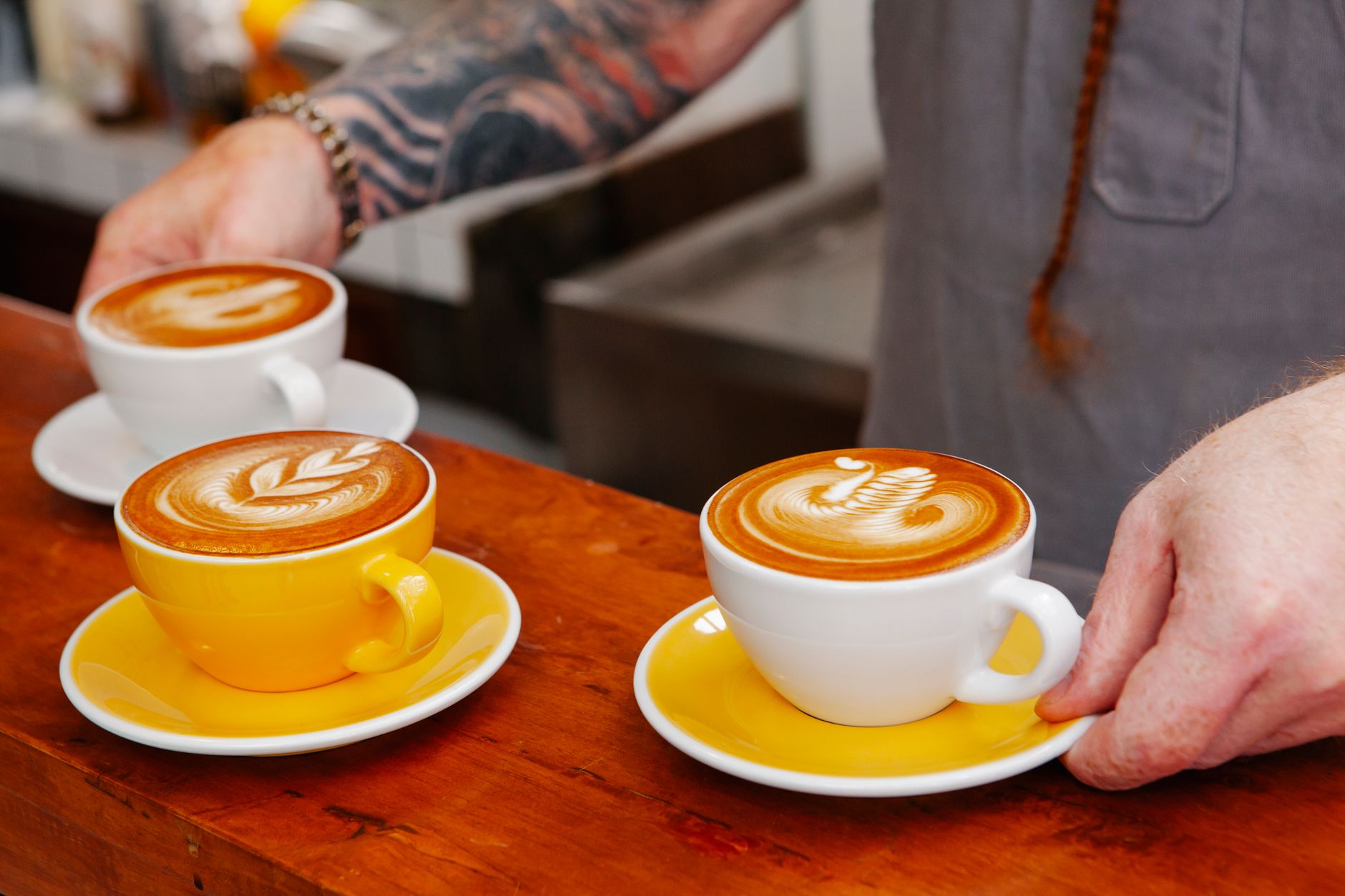 Smiling senior resident admiring latte art presentation