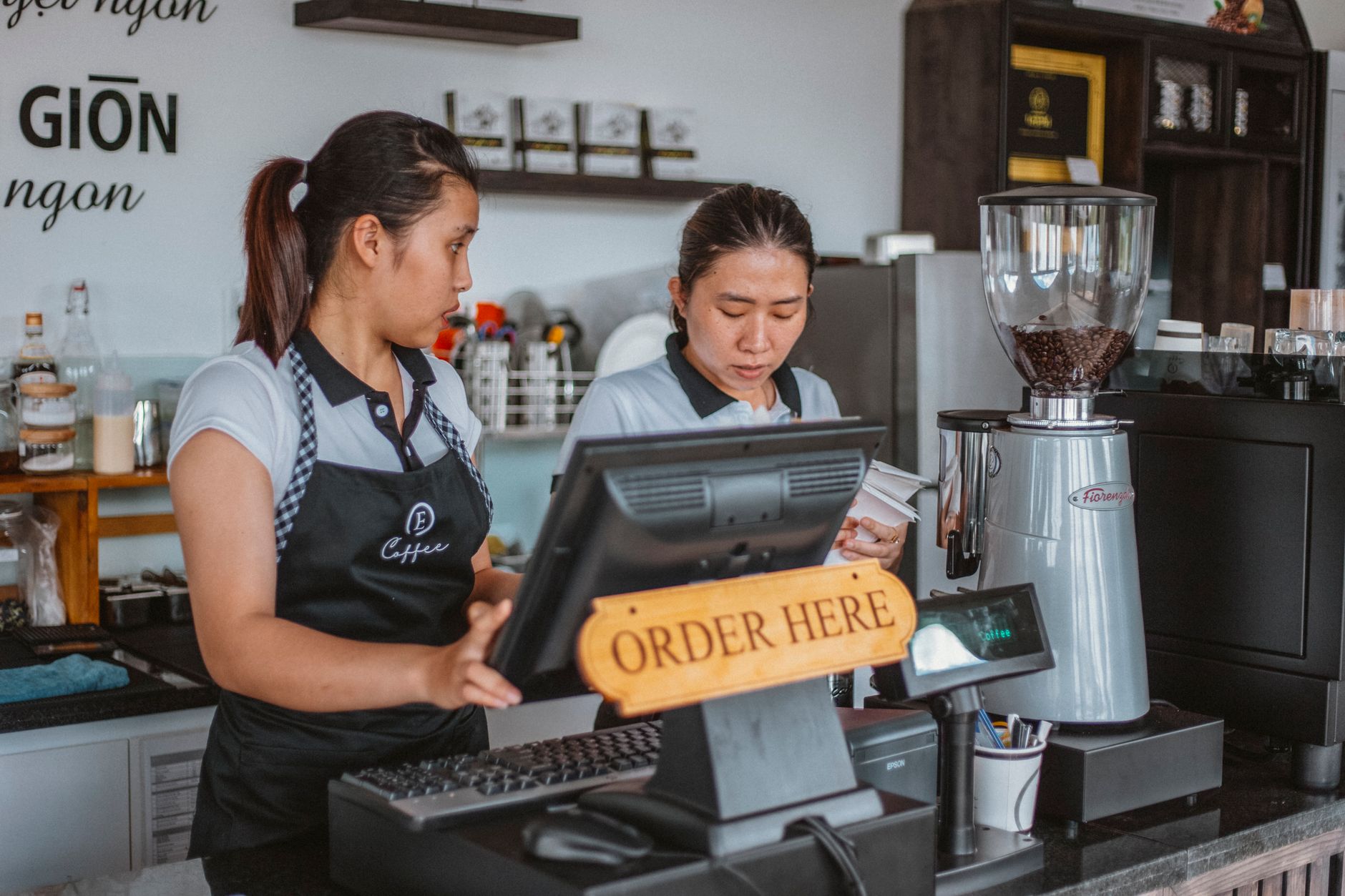 Professional barista station in bakery with tampers and milk pitchers