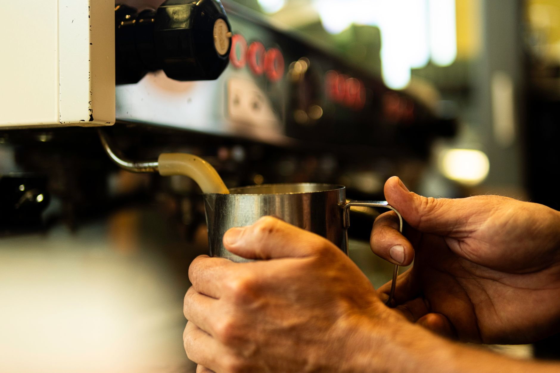Professional barista making heart design in latte foam