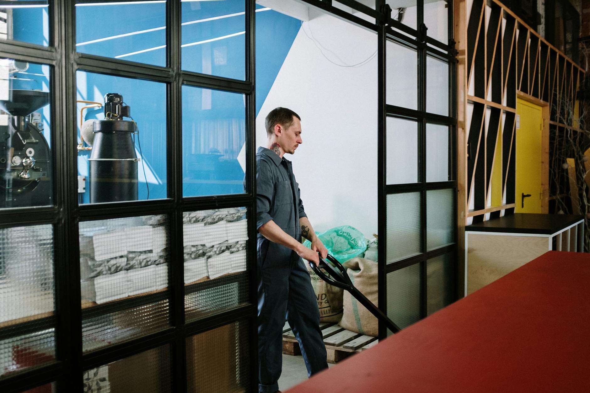 Industrial coffee roaster in action inside factory