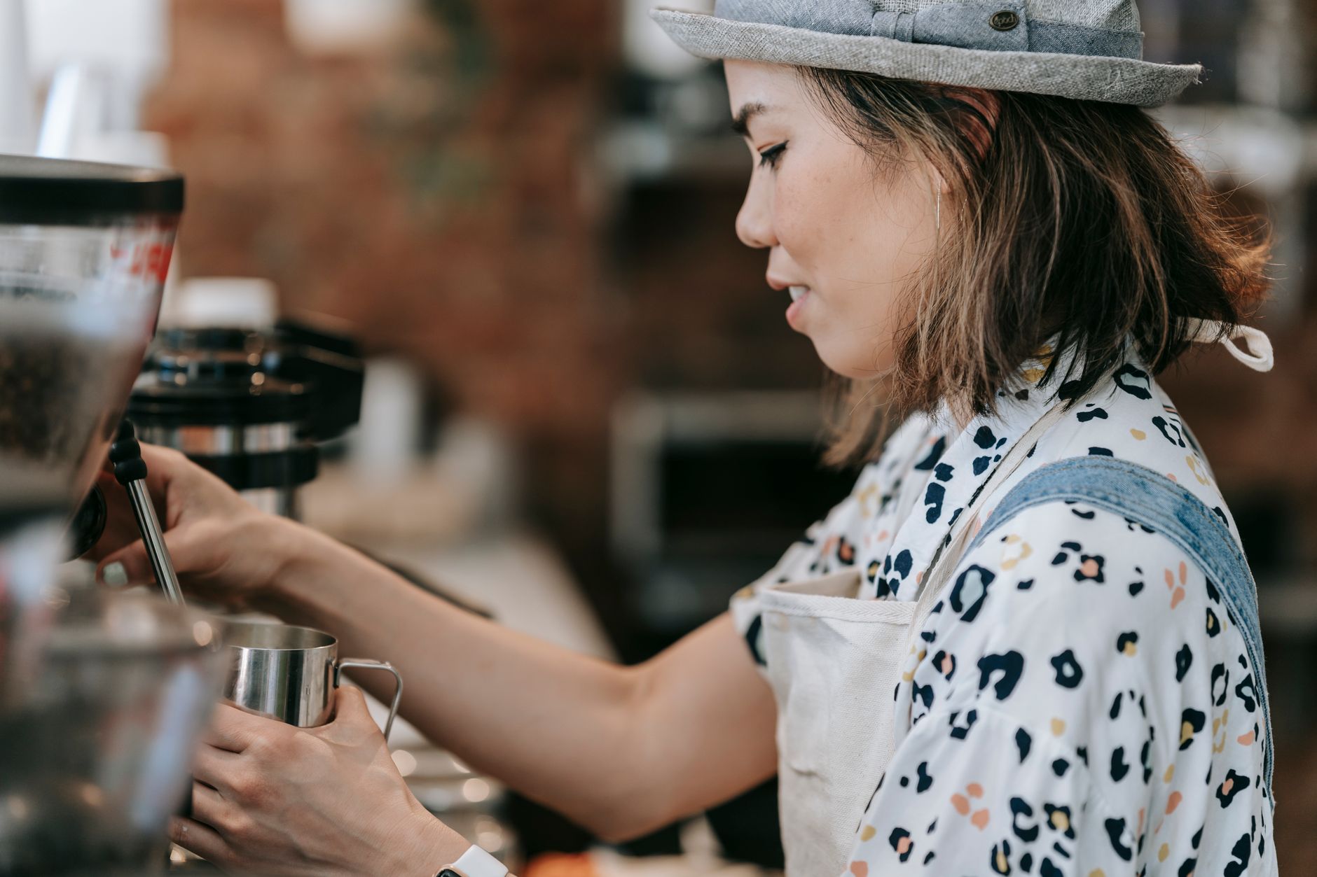Professional barista serving coffee in a commercial setting