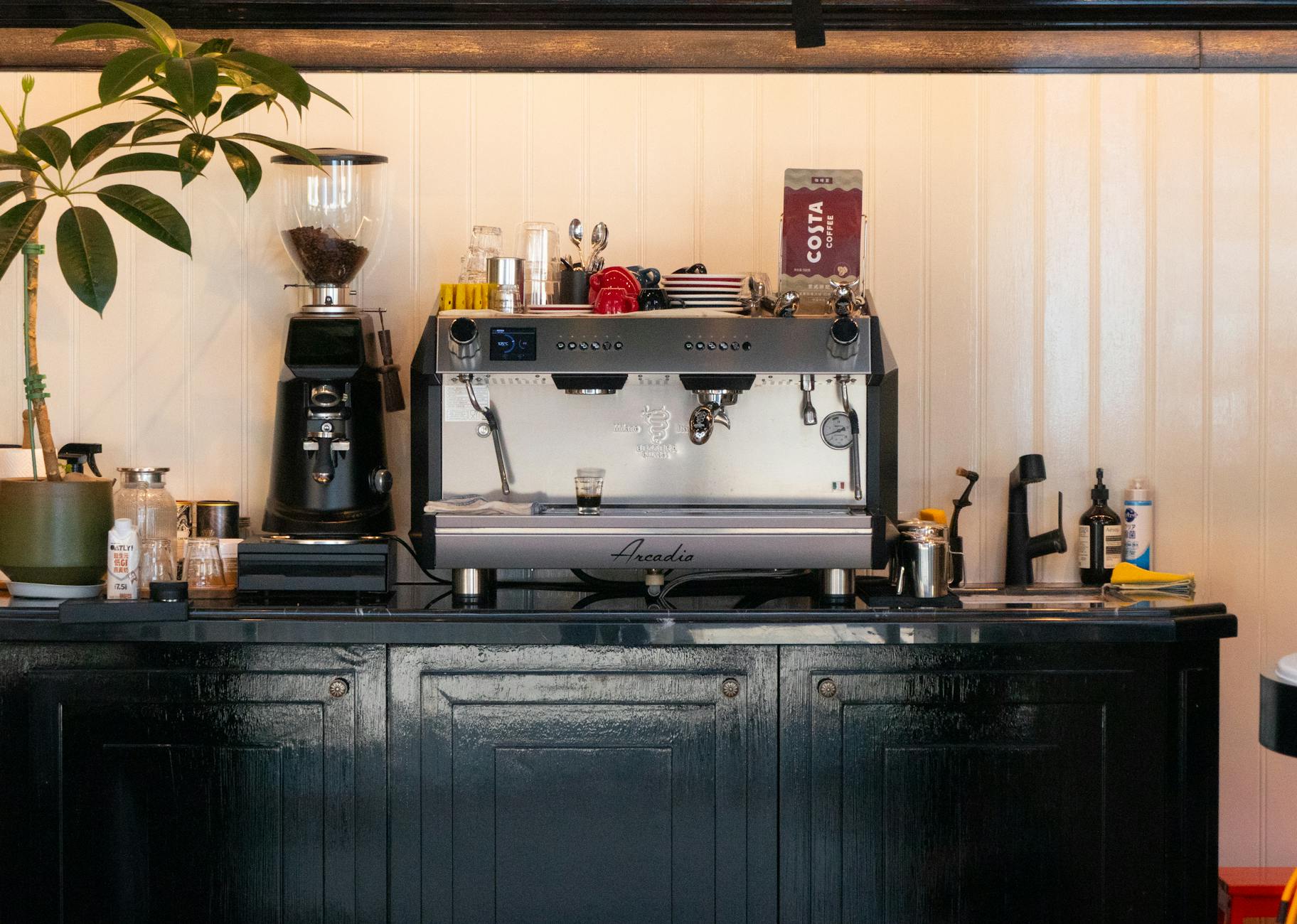 Modern office coffee station with employees brewing