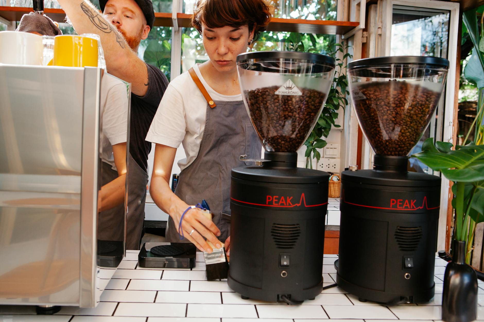 Modern office coffee station with employees pouring drinks