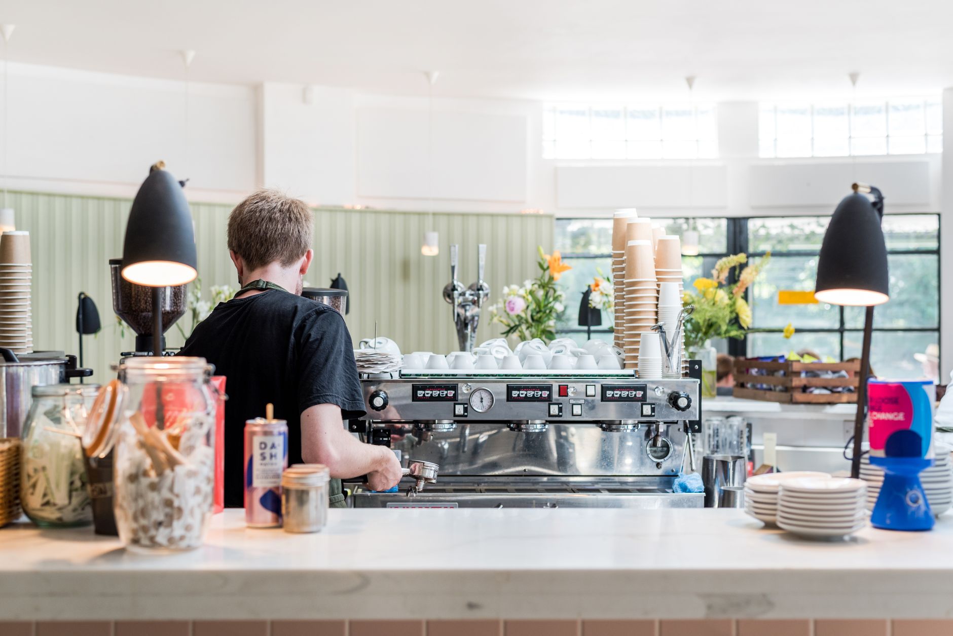 Highly skilled barista preparing specialty coffee drink in a modern cafe setting