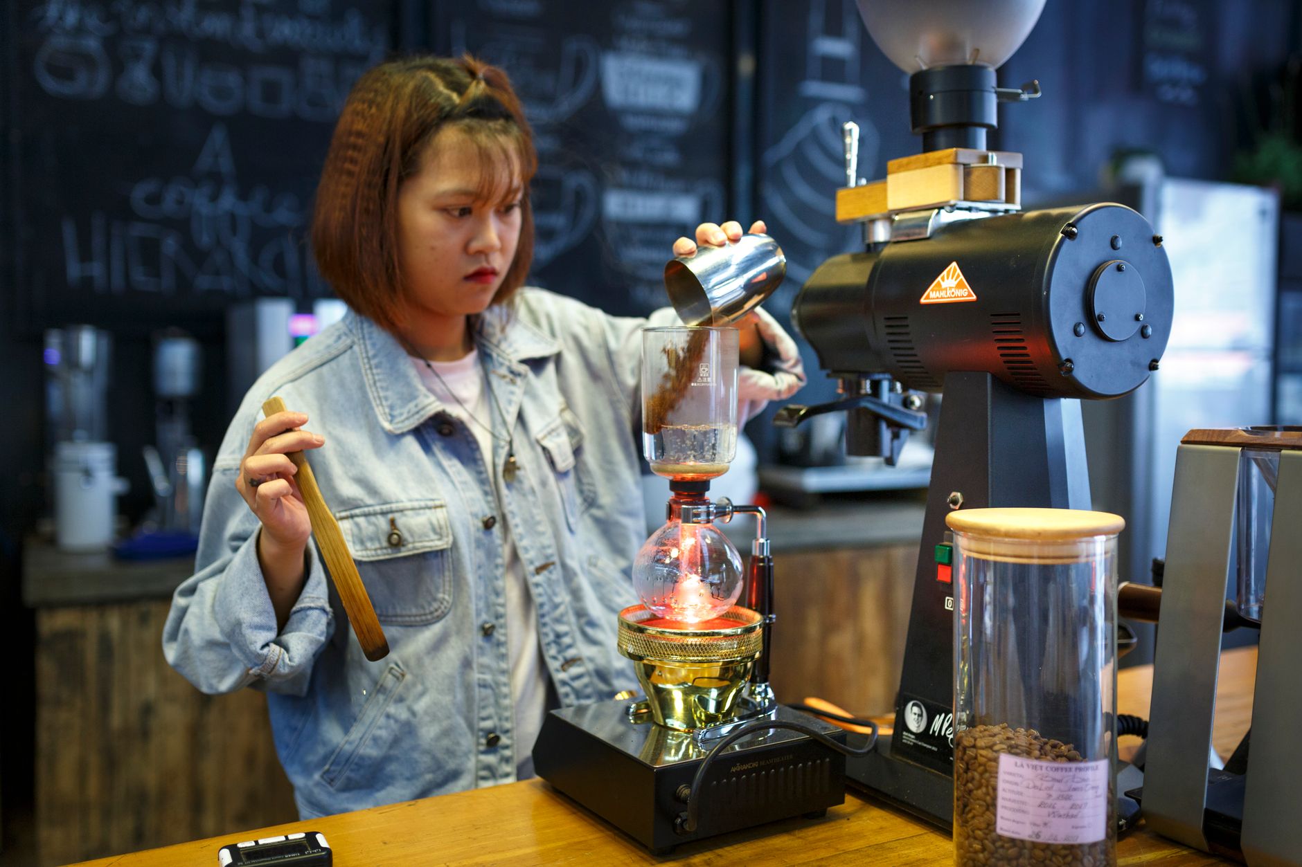 Professional barista crafting espresso drinks in a commercial kitchen
