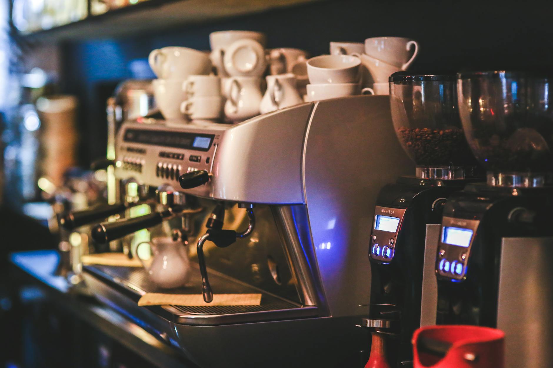 Commercial coffee grinder in a busy cafe setting