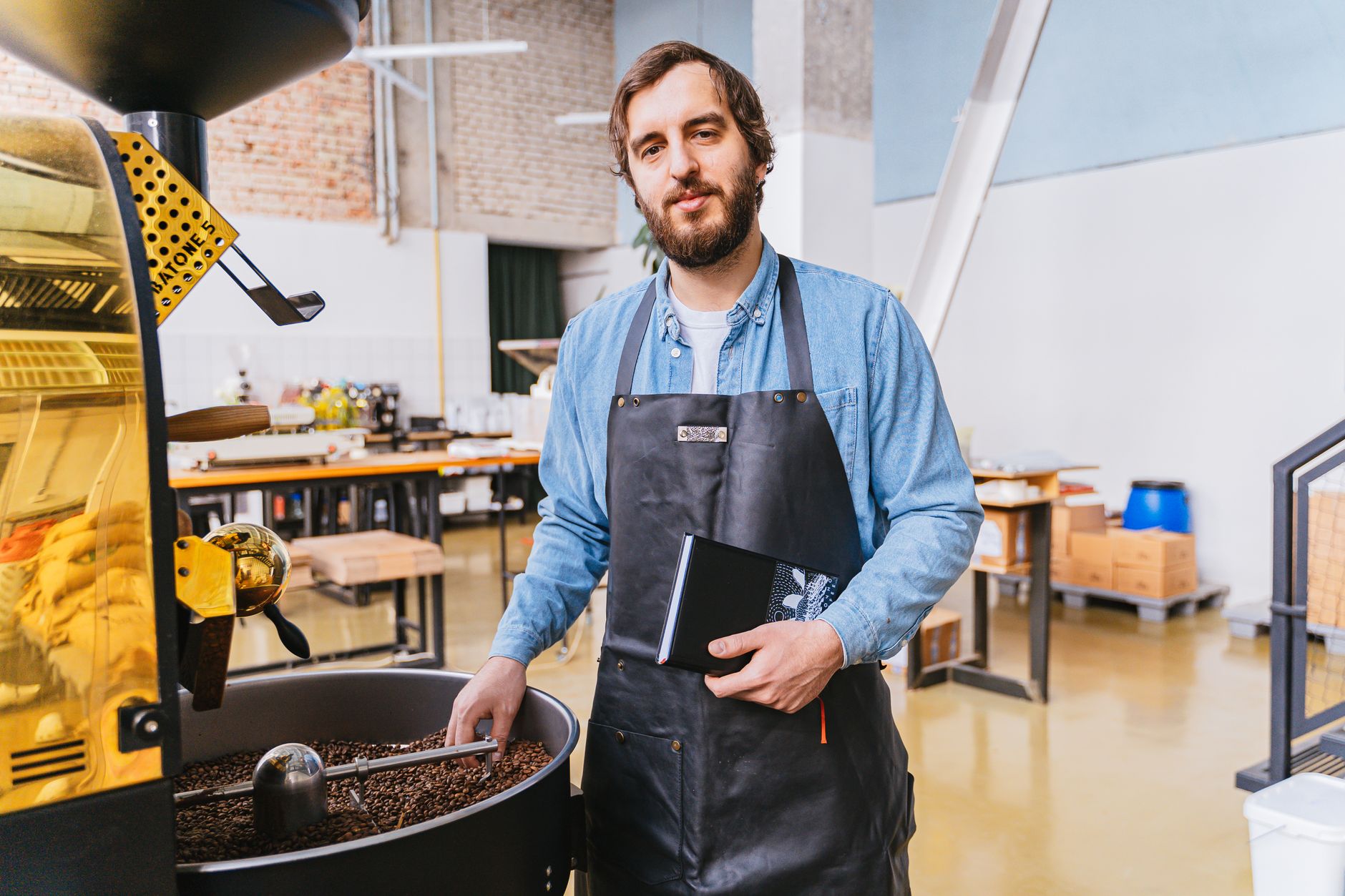 Coffee technician servicing espresso machine in cafe