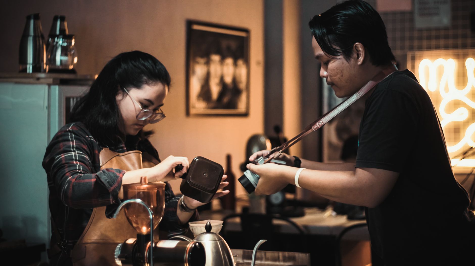 Professional barista training a restaurant staff member