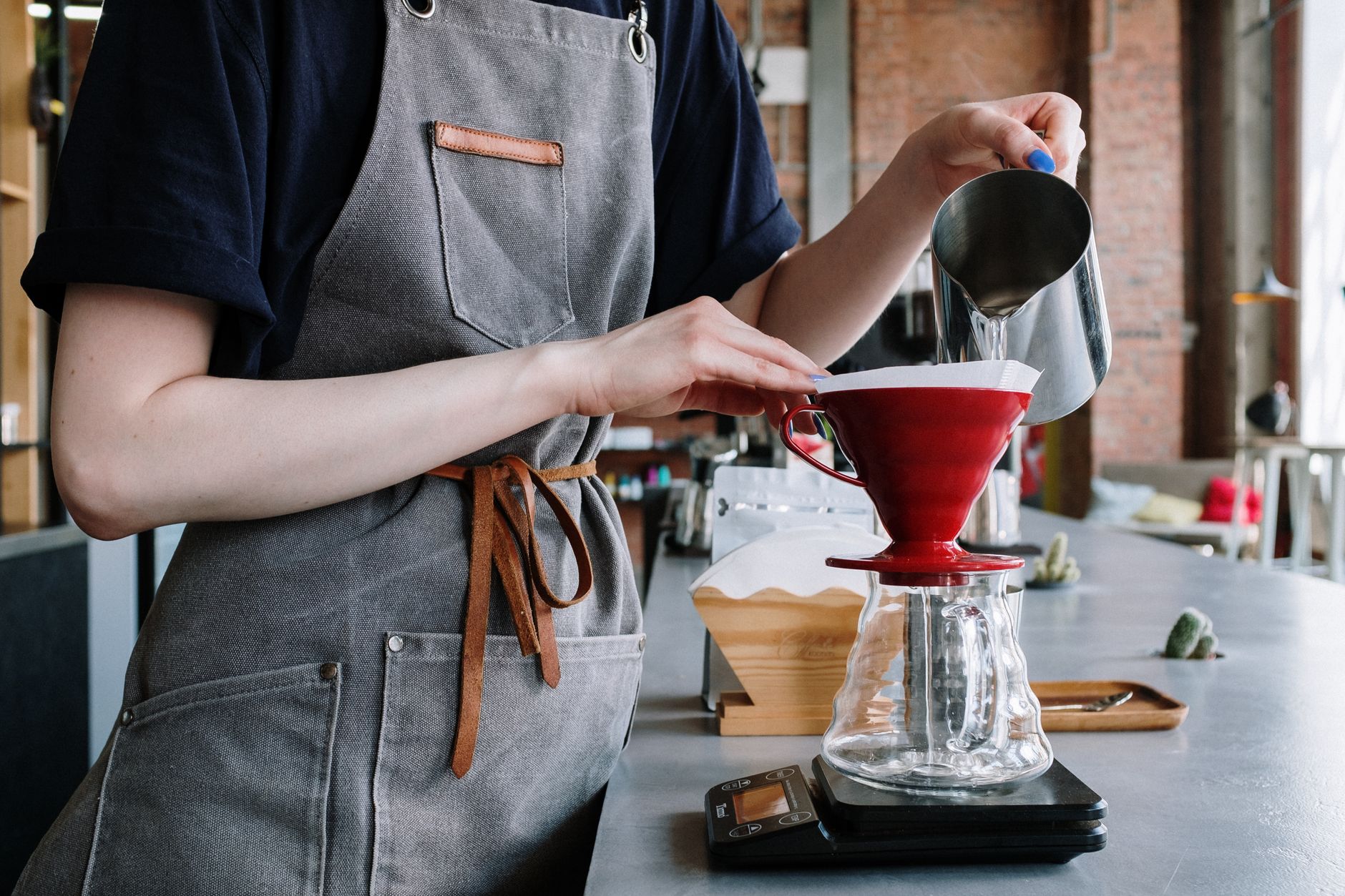 Professional barista preparing fresh bean-to-cup coffee in Charleston, SC cafe