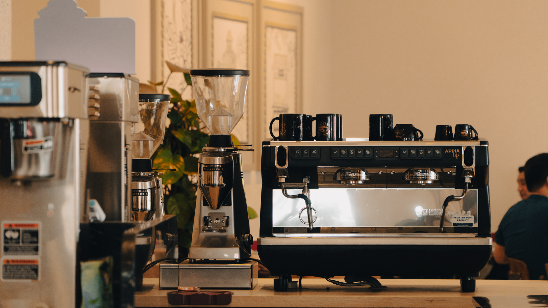 Coffee technician performing equipment maintenance in commercial kitchen