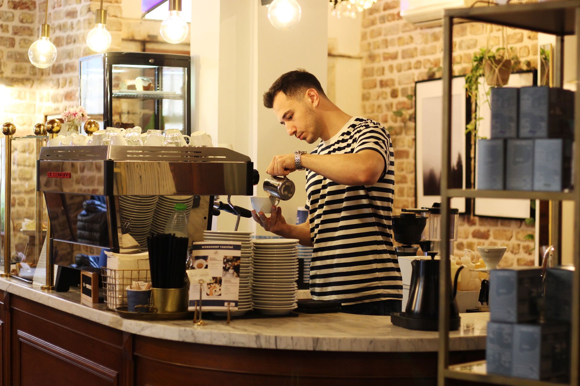 Barista using digital calipers to measure portafilter basket interior diameter before selecting a tamper