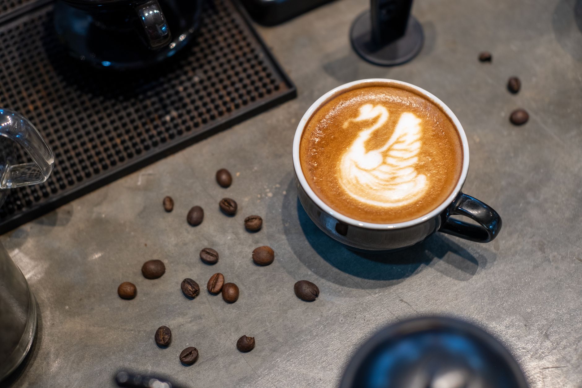 Professional barista creating intricate latte art design