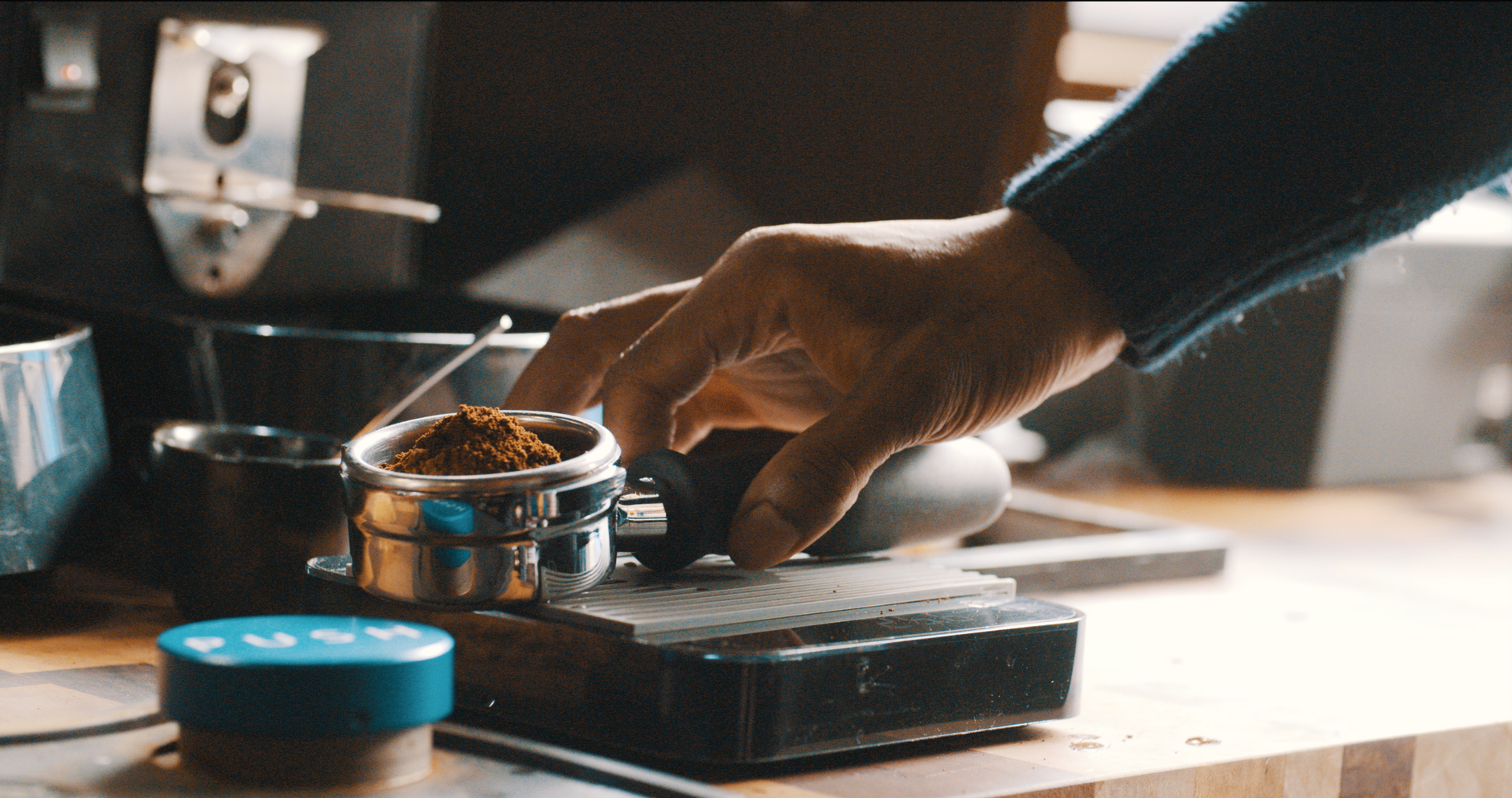 Barista weighing coffee beans in bakery environment