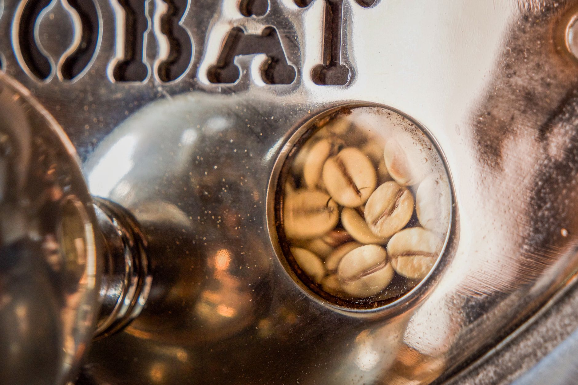 Detailed view of coffee beans inside a roasting machine, showcasing the texture.