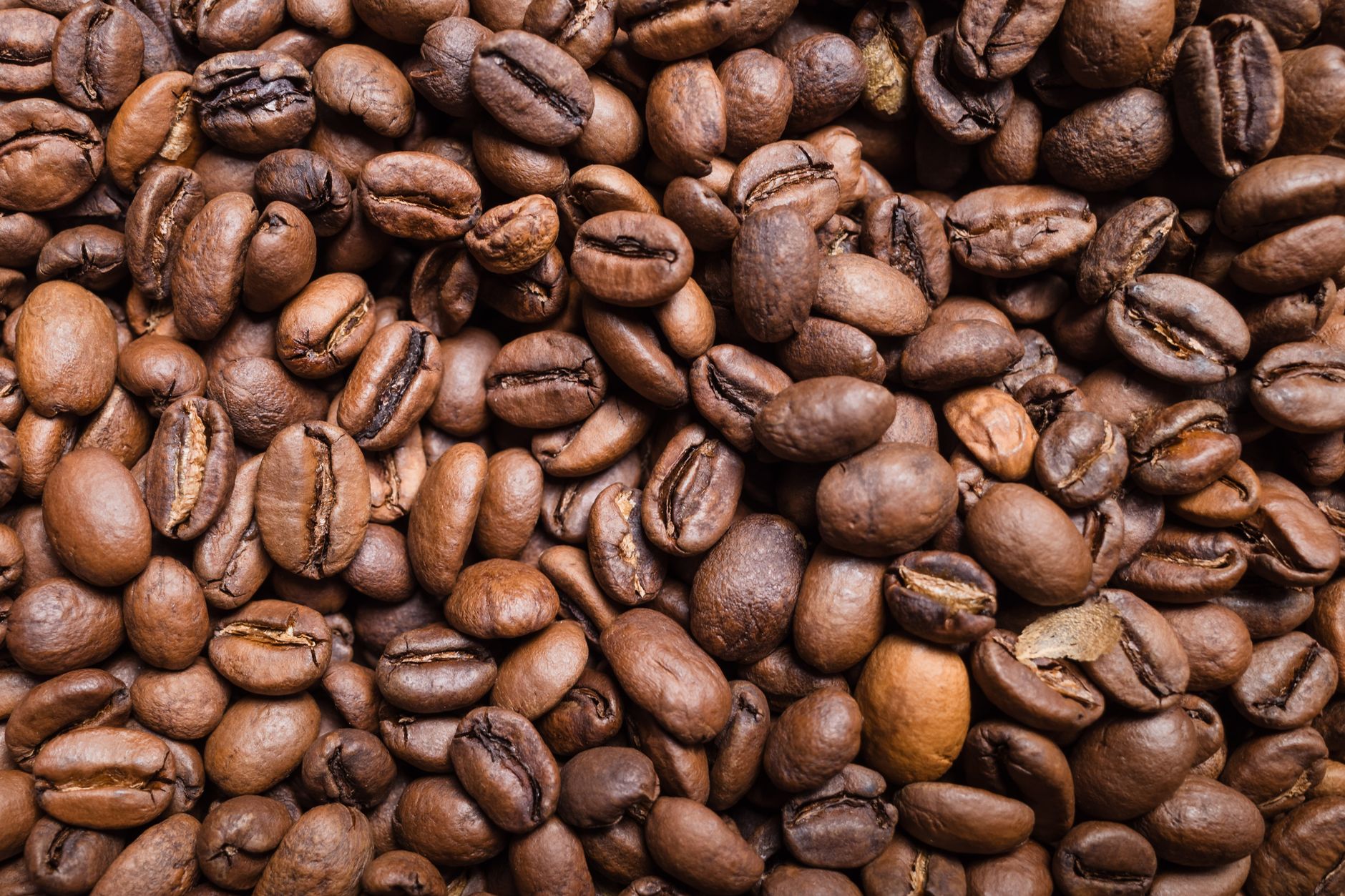 High-resolution close-up of roasted coffee beans, showcasing a rich texture perfect for food photography.