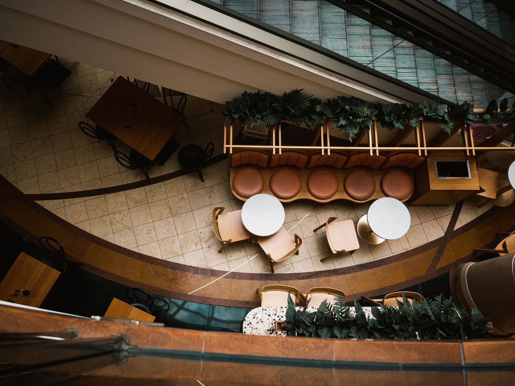 Aerial view of a stylish indoor café with tables, chairs, and decorative elements. Perfect for design inspiration.