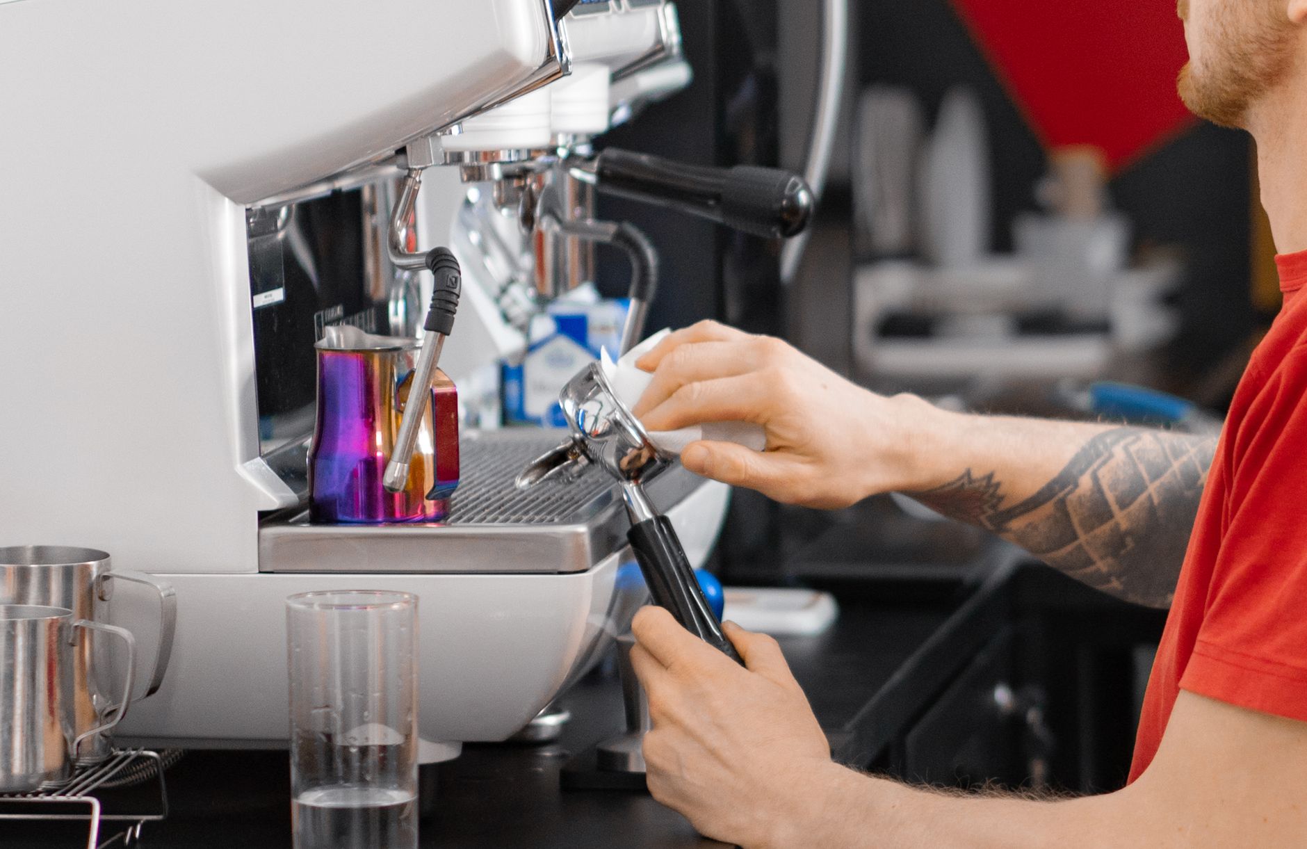 Close-up of a barista using an espresso machine to prepare coffee, showcasing professional technique.